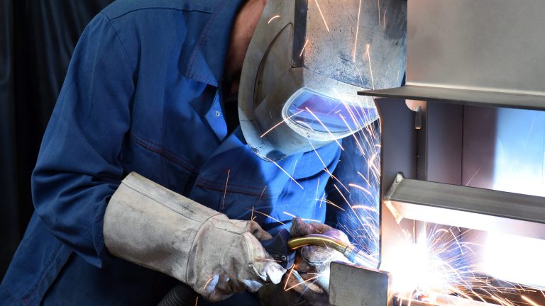welder works in metal construction – construction and processing